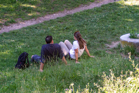 terni,italy july 06 2020:two boyfriends in the park in peaceのeditorial素材