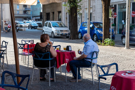 terni,italy july 10 2020:couple of gentlemen having breakfast at the bar in the center of terniのeditorial素材