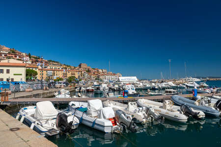Porto Santo Stefano harbor with boats and the seaの写真素材
