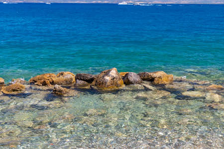 rocks in the middle of the sea in porto santo stefanoの写真素材