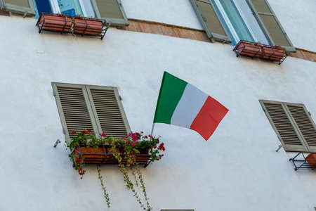 Italian flag placed on a balconyの写真素材