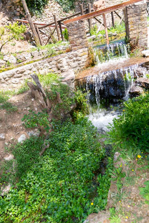 Small stream of water that forms a waterfallの写真素材