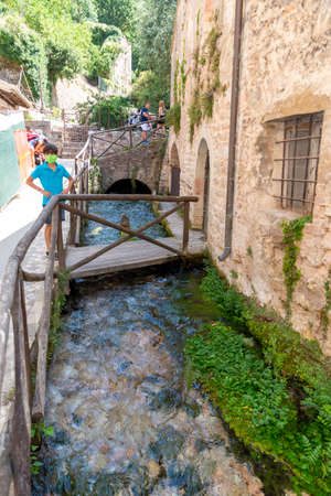 Streams that form small waterfalls in the center of the town of rasigliaの写真素材