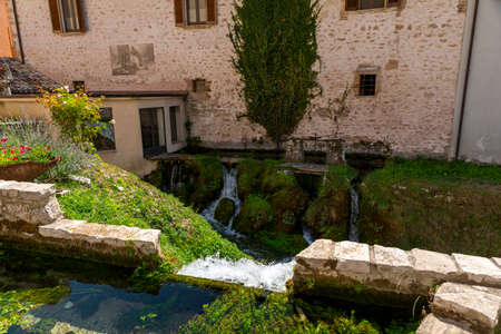 Streams that form small waterfalls in the center of the town of rasigliaの写真素材