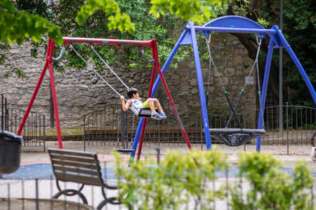 child at the park on swingの写真素材