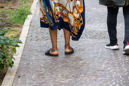 legs of African woman with slippers on her feetの写真素材