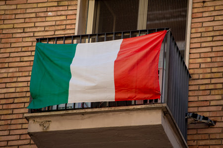 Italian flag hanging on a windowのeditorial素材