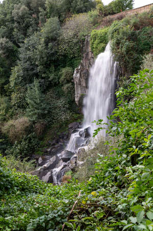 the waterfall of nepi surrounded by greenery in provoncia di romeの写真素材