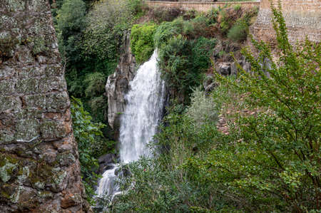 the waterfall of nepi surrounded by greenery in provoncia di romeの写真素材