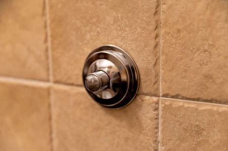 chrome bathroom flush button to drain the toilet on the wallの写真素材