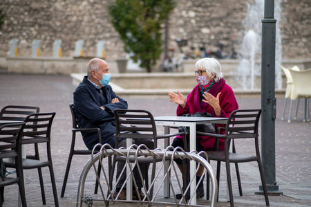 terni, italy october 13 2020: black man sitting on a bench at the parkのeditorial素材