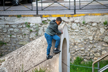 terni, italy october 13 2020: black man sitting on a bench at the parkのeditorial素材