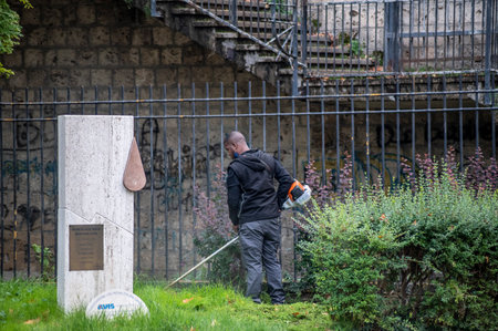 terni, italy actober 17 2020: black gardener who works for the municipality of terniのeditorial素材