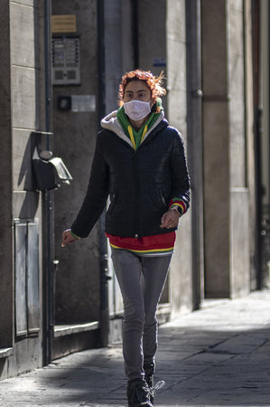 woman with medical mask walking downtownのeditorial素材