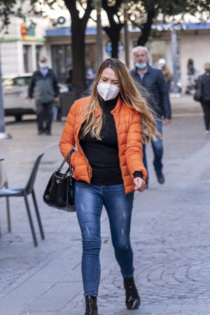 woman with medical mask walking downtownのeditorial素材