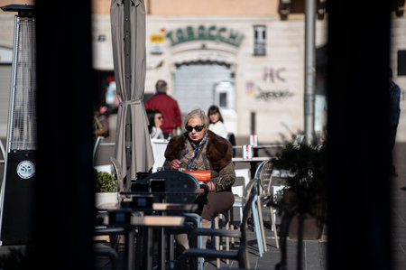 terni, italy october 21 2020: woman sitting at a table in an outdoor cafeのeditorial素材