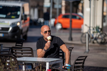 terni, italy october 21 2020: sitting man eating an ice cream coneのeditorial素材