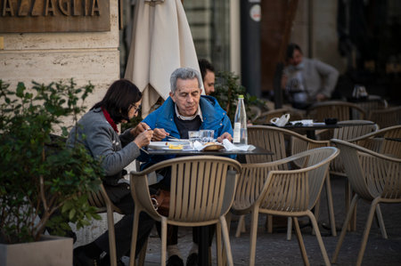terni, italy october 21 2020: husband and wife sitting at the bar having lunchのeditorial素材