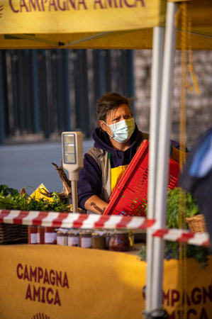 walking woman at market with medical maskのeditorial素材