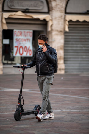 boy with medical mask causes covid 19 and carries the scooterのeditorial素材