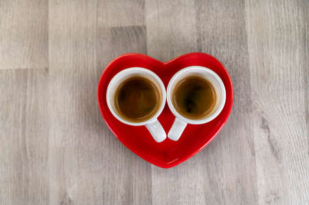 two teaspoons of coffee with a heart-shaped saucer and a teaspoonの写真素材