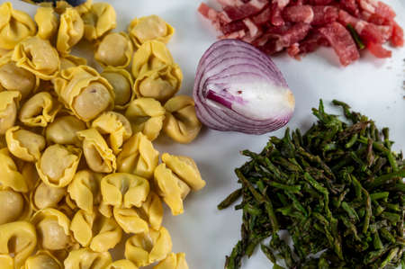 ingredients for cappelletti pancetta and asparagus creamed in a pan with parmesanの写真素材