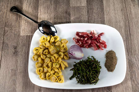 ingredients for cappelletti pancetta and asparagus creamed in a pan with parmesanの写真素材