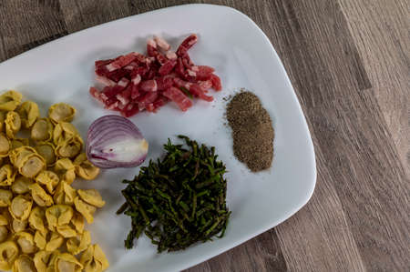 ingredients for cappelletti pancetta and asparagus creamed in a pan with parmesanの写真素材