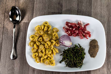 ingredients for cappelletti pancetta and asparagus creamed in a pan with parmesanの写真素材