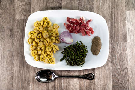 ingredients for cappelletti pancetta and asparagus creamed in a pan with parmesanの写真素材