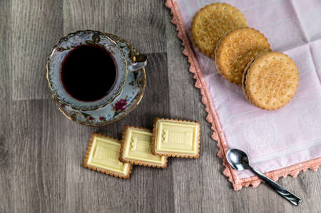 combination of food with tea and biscuits on a wooden table from aboveの写真素材
