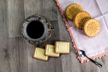 combination of food with tea and biscuits on a wooden table from aboveの写真素材