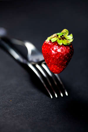 composition with strawberry and forks viewed in various perspectives on wooden tableの写真素材