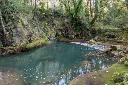 black river and its glimpses after the marble waterfall in winterの写真素材