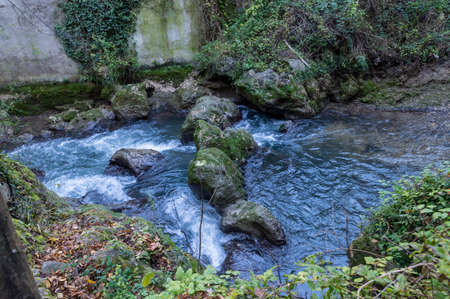 black river and its glimpses after the marble waterfall in winterの写真素材