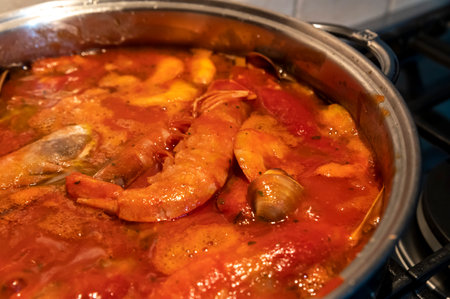 tomato fish soup with seafood, clams, Argentine prawnsの写真素材