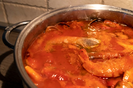 tomato fish soup with seafood, clams, Argentine prawnsの写真素材