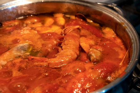 tomato fish soup with seafood, clams, Argentine prawnsの写真素材
