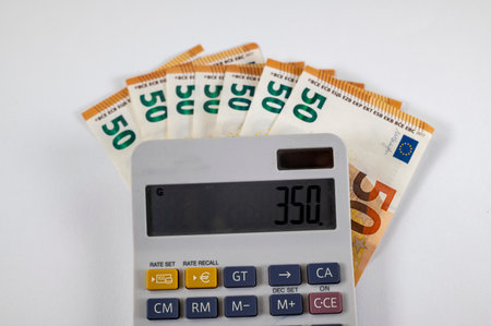 50 euro bills with calculator and graph on white backgroundの写真素材