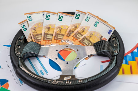 50 euro banknotes with statistics and calculator on white backgroundの写真素材
