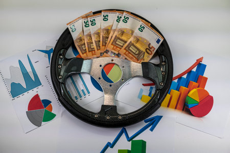 50 euro banknotes with statistics and calculator on white backgroundの写真素材
