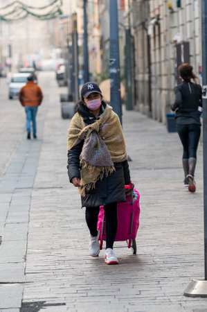terni.italy jenuary 30 2021:woman with medical mask and shopping trolley in city centerのeditorial素材