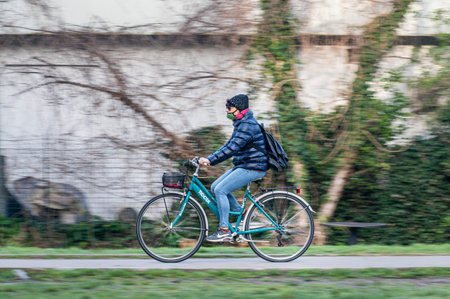 terni, italy february 24 2021: oanning of man on bicycle at the parkのeditorial素材
