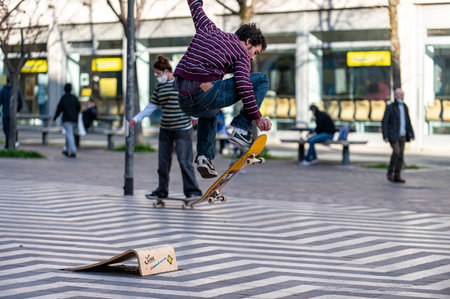 terni, italy march 16 2021: boys doing skateboard stunts in the cityのeditorial素材