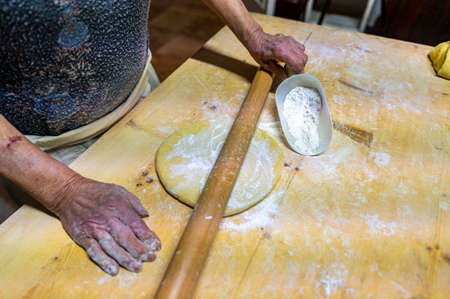 detail roll out the dough with a rolling pin and then make tagliatelleの写真素材