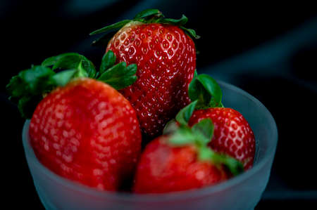 cup of ripe strawberries on wooden backgroundの写真素材