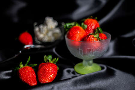 cup of ripe strawberries on wooden backgroundの写真素材