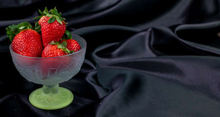 cup of ripe strawberries on wooden backgroundの写真素材