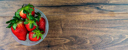cup of ripe strawberries on wooden backgroundの写真素材