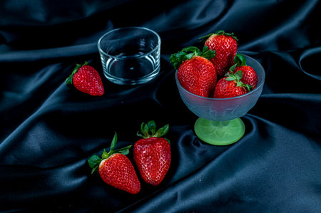 cup of ripe strawberries on wooden backgroundの写真素材